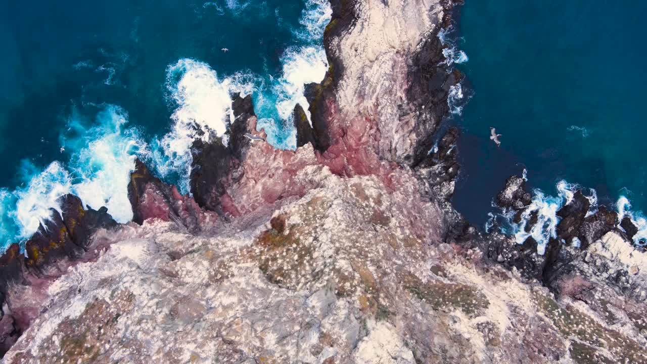 Aerial View of Dramatic Rocky Coastline and Ocean Waves