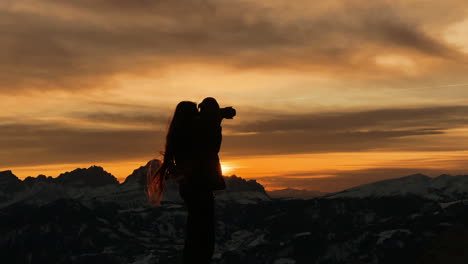 sunset silhouette of a woman in the mountains
