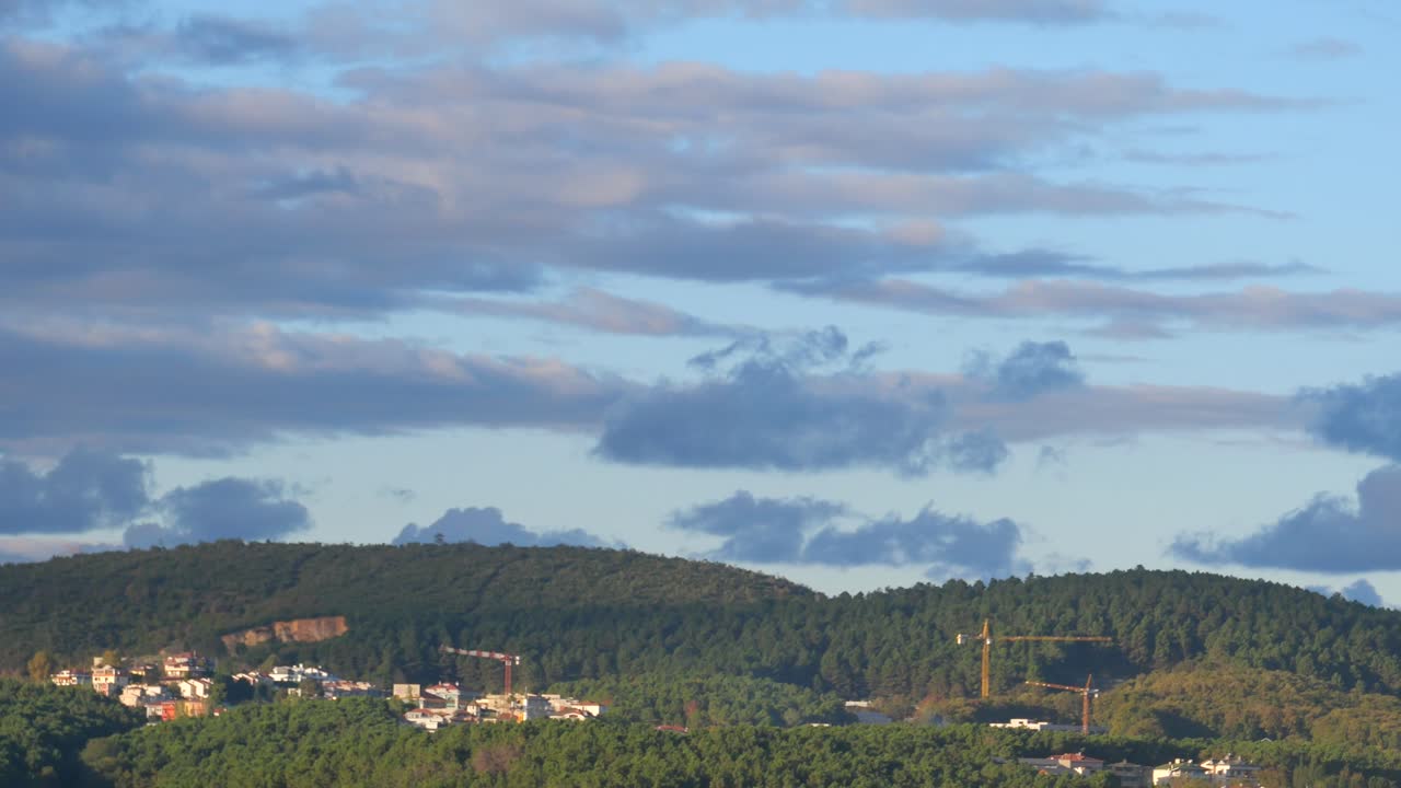 Panoramic View of a City and Forest with Clouds