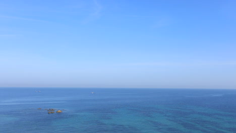 calm tunisian beach with clear blue water and sky, creating a peaceful and serene atmosphere