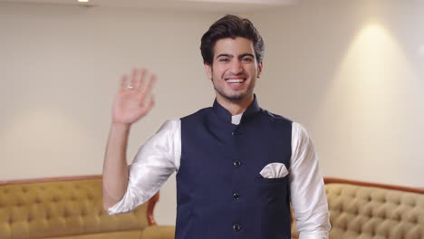 Happy-Indian-man-saying-hello-and-waving-hand