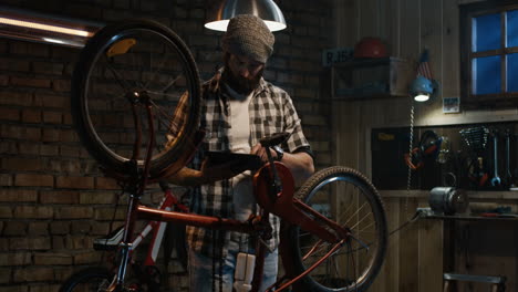 man repairing a bicycle in a garage