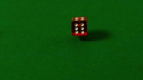 los dados rojos rodando en la mesa del casino