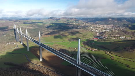 millau viaduct with the city in background aerial drone shot day time gorge