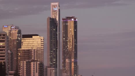 skyscrapers illuminated during sunset in the city