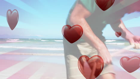 animation of hearts falling over caucasian family at beach