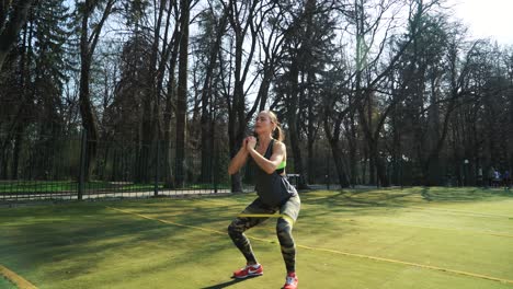 athletic woman working out at the stadium using rubber bands. working out hard. lifestyle sport.