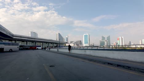 city bus station with modern skyscrapers in the background