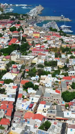 vertical drone shot of the old town and the harbor of rhodes city, greece