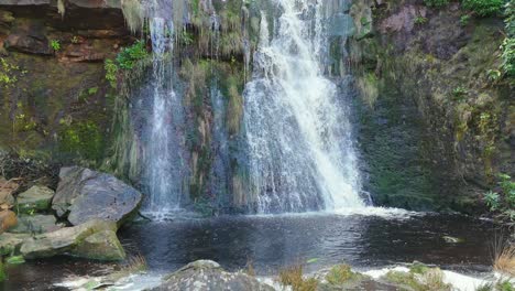 Aerial-drone-footage-of-a-tall-rocky-waterfall-in-the-Yorkshire-Dales,-Pennies