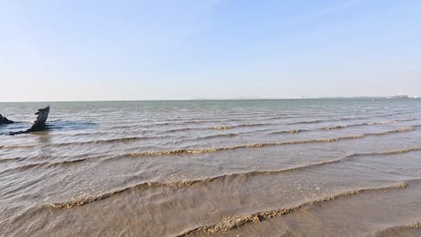 waves lap against a stranded shipwreck