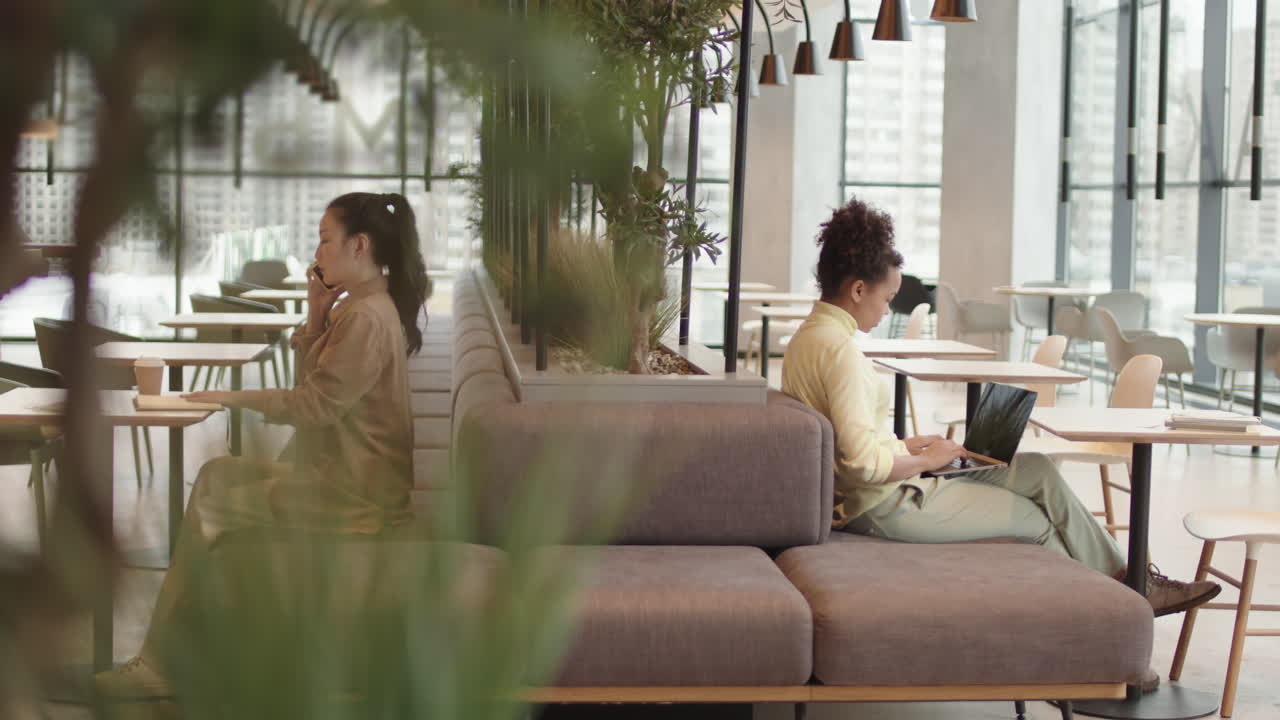 Women Sitting on Couch in Modern Restaurant