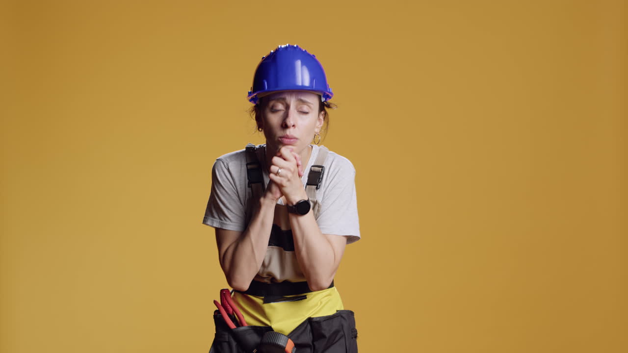 Portrait of construction worker doing prayer hands gesture