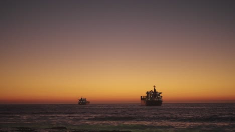 sunset of 2 large ships on the coast of chile