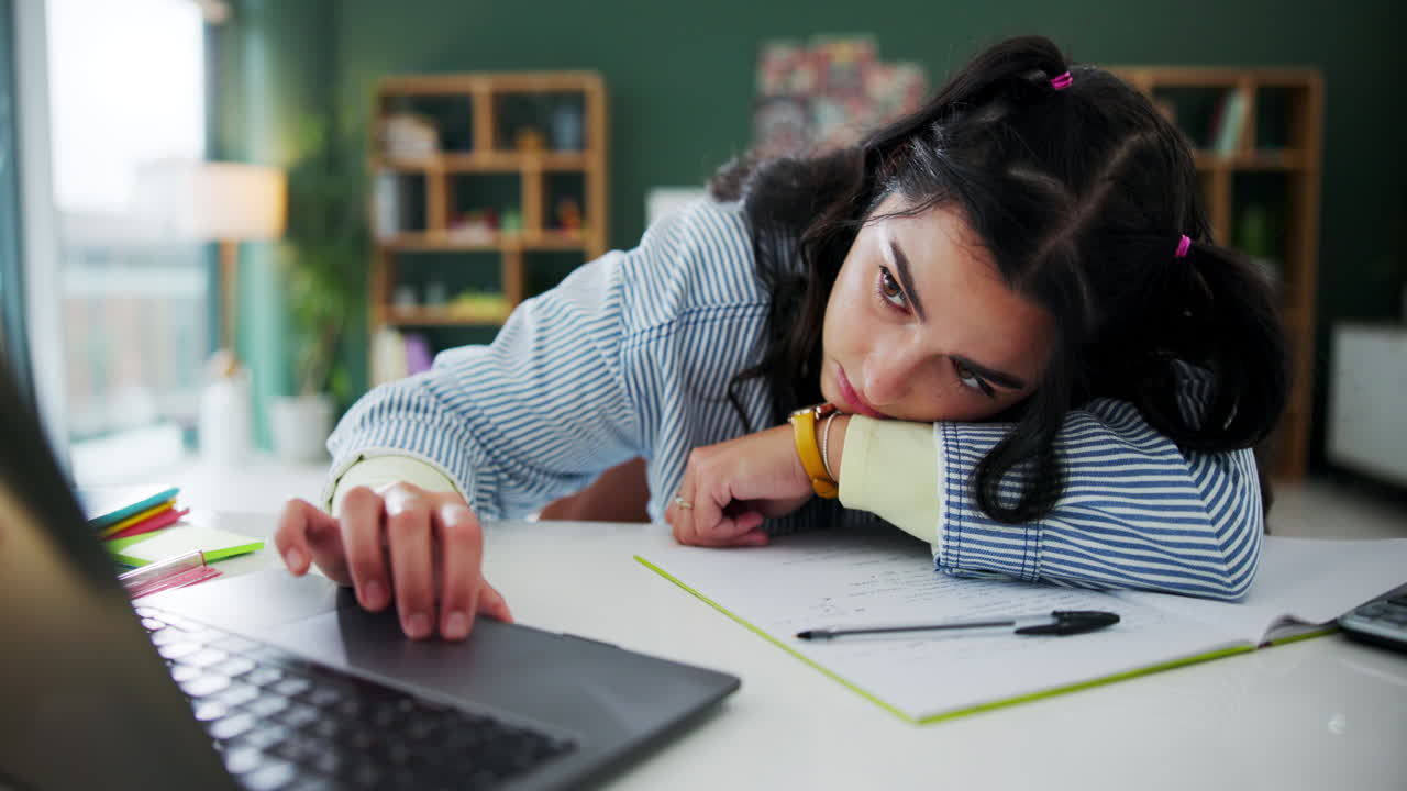 Tired student studying at desk