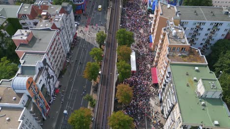 train on elevated railroad, stunning aerial top view flight csd pride love parade 2023 in city berlin germany summer day