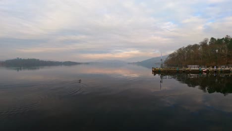 misty scene over lake windermere in the english lake district national park