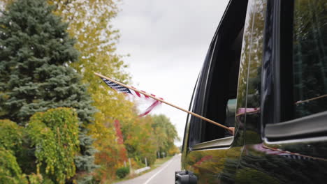 usa flag flying from car window