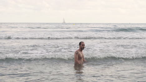 Handsome-hispanic-bathing-off-grid-style-at-mediterranean-sea-Barcelona