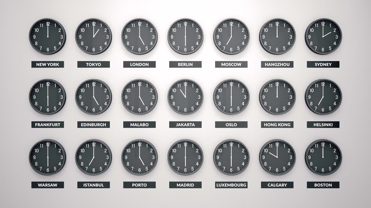 Many Round Clocks Are Going And Showing Different Time For Different Cities Around The World. White Wall Behind.