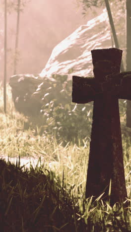 stone cross in a misty forest