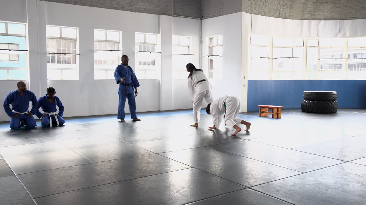 Practicing judo, group of people in martial arts uniforms in dojo
