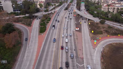 Aerial-View-of-Traffic-on-US-101-Highway,-Los-Angeles-USA,-Hollywood-Freeway-and-Interchange-by-Downtown-Apartment-Buildings