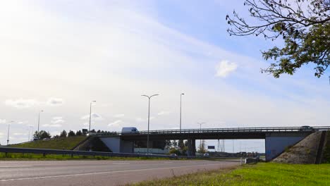 driving on a highway under a bridge