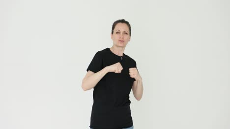 woman demonstrating self-defense or boxing moves on a white background
