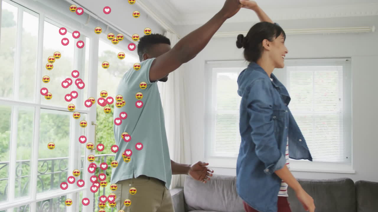 couple dancing in suburban living room, showcasing floating social media icons for marketing