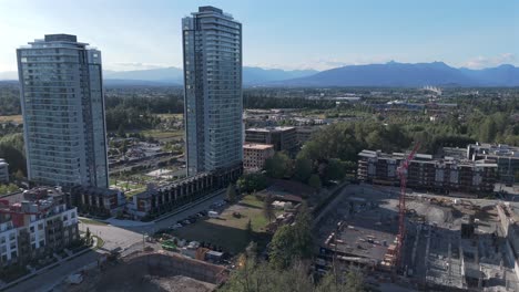construction tower cranes working on the building site in the city of langley in british columbia, canada. aerial drone shot