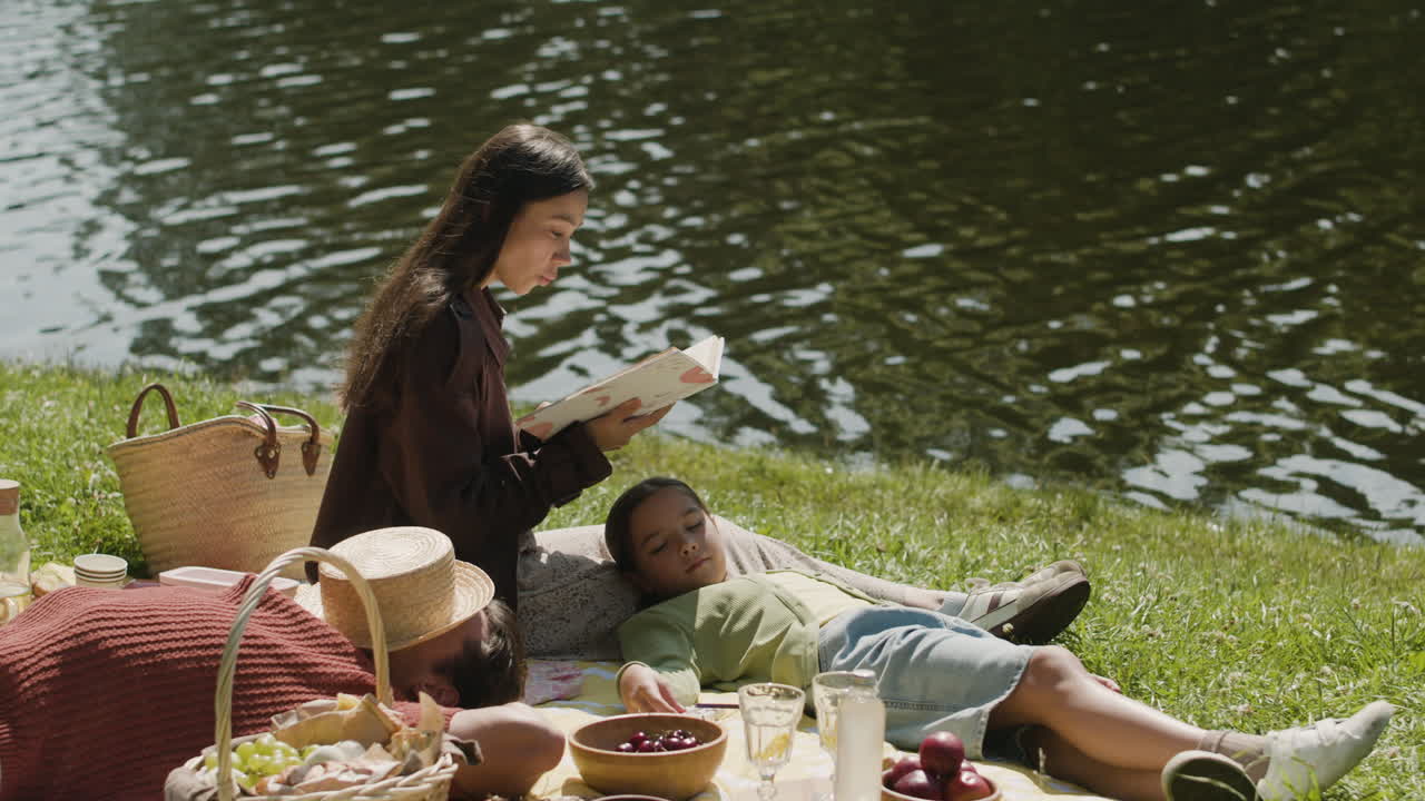 Family enjoying a picnic by the lake