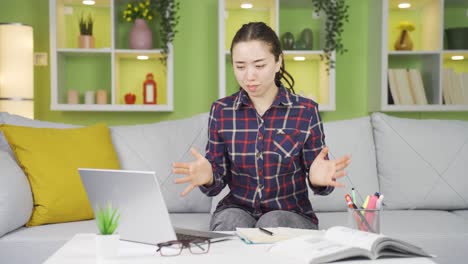 frustrated young asian woman seeing her failure on a laptop.