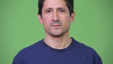 hispanic man against green background