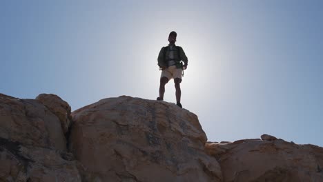 african american man exercising outdoors hiking in countryside on a coast