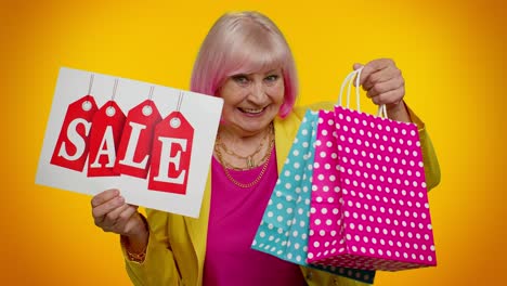 elderly granny woman showing sale inscription banner text, advertising discounts low holidays prices