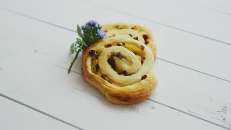 Delicious-pastry-with-raisins-on-white-wooden-table