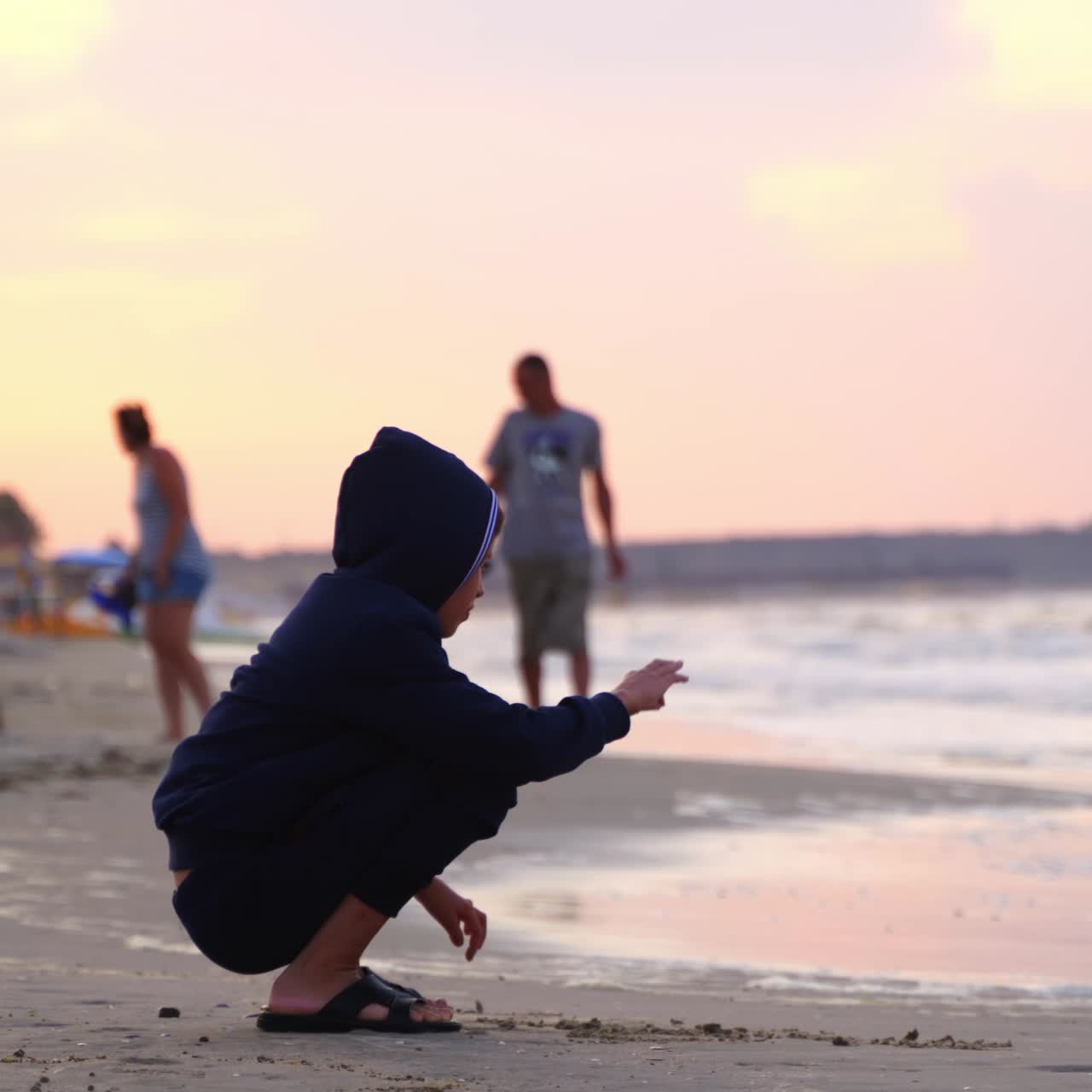 Boy sitting on beach