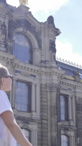 a girl and a woman explore a bridge and admire grand architecture a young girl and a woman cross a picturesque bridge pausing before a majestic building the video explores themes of admiration for architecture