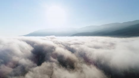 sunrise over clouds and mountains