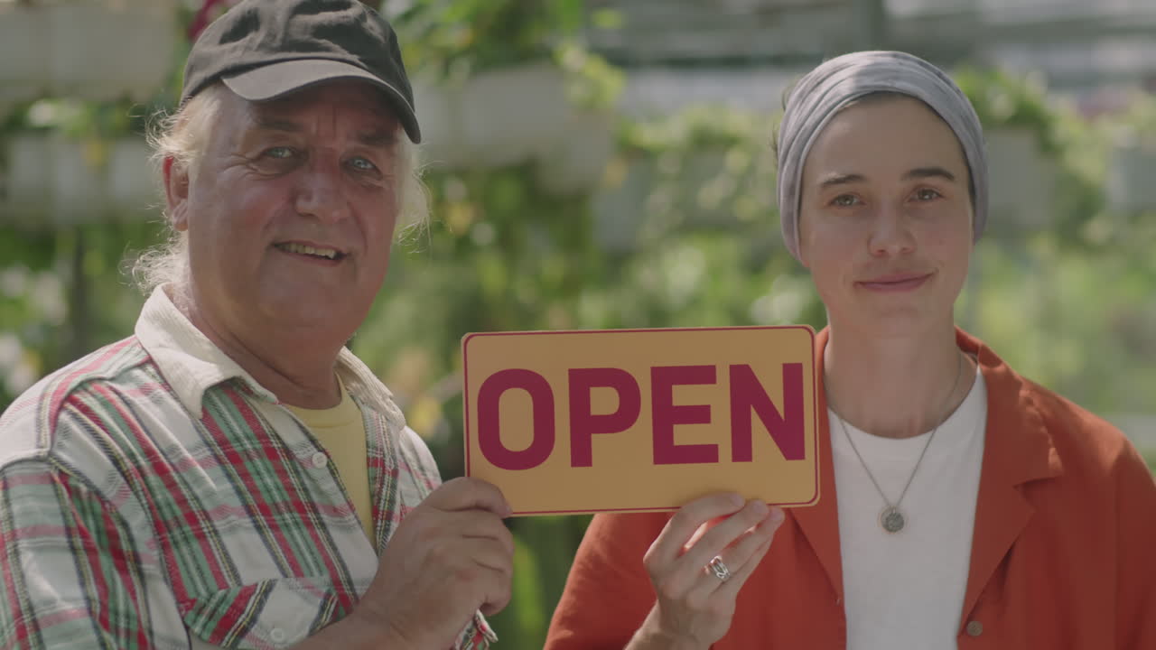 Portrait of Plant Nursery Workers with Open Sign