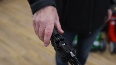 Man-pressing-down-the-handle-for-the-Snow-cleaner