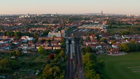 Head-on-reversing-drone-shot-of-London-Underground-piccadilly-line-train-leaving-the-station