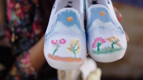 close-up of hand-painted slip-on shoes with nature designs