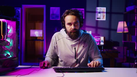 Man plays intense videogame tournament online during stream with audience, spamming attack buttons