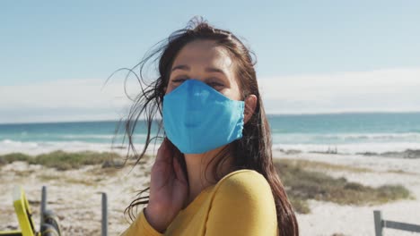 happy caucasian woman wearing face masks standing near beach buggy