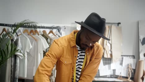 Cheerful-Young-Designer-Drawing-An-Outline-On-The-Cloth-In-Studio-And-Then-Smiles-At-Camera