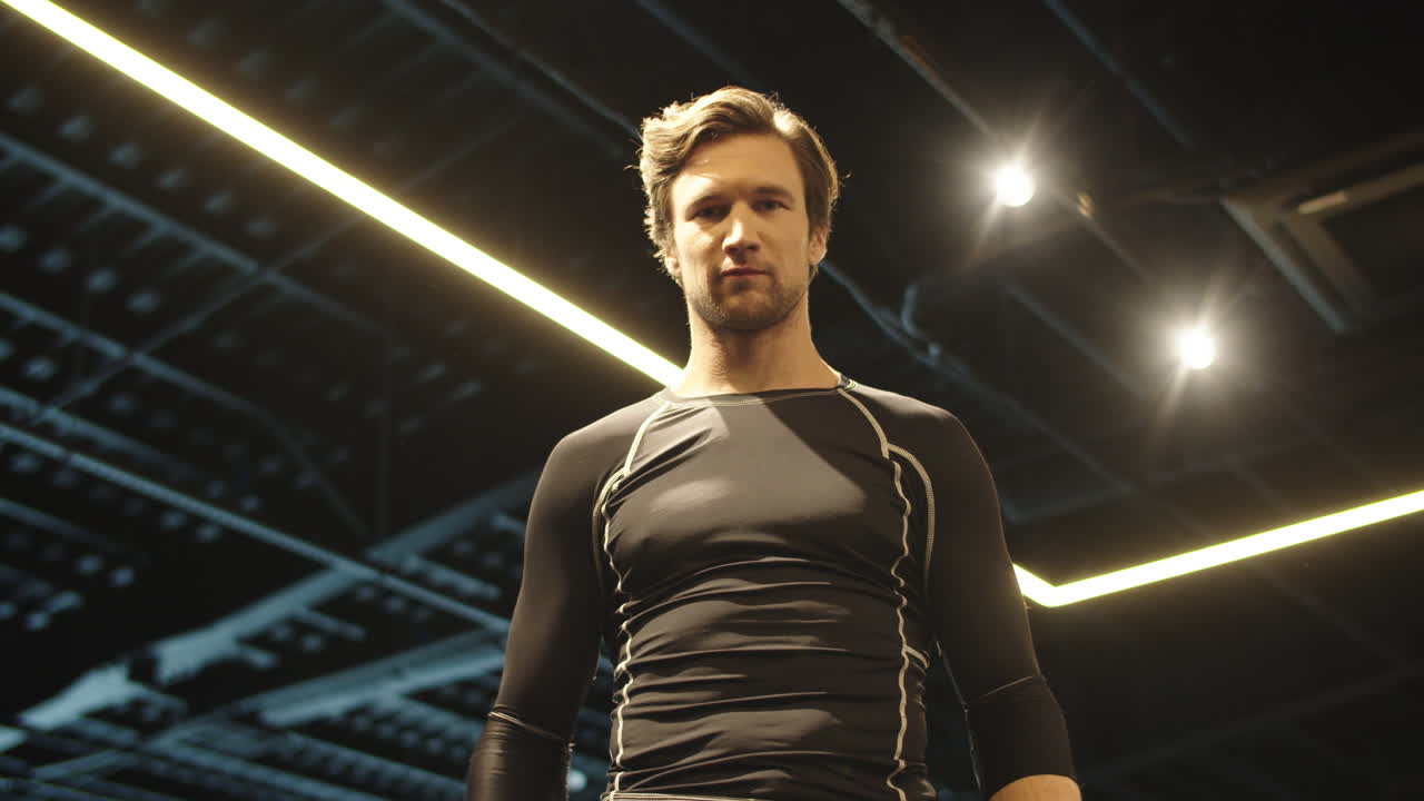 체력 강한 남자가 스포츠 클럽에서 힘을 보여줍니다. 스포츠 남자가 체육관에서 주먹을 때리고 있습니다.