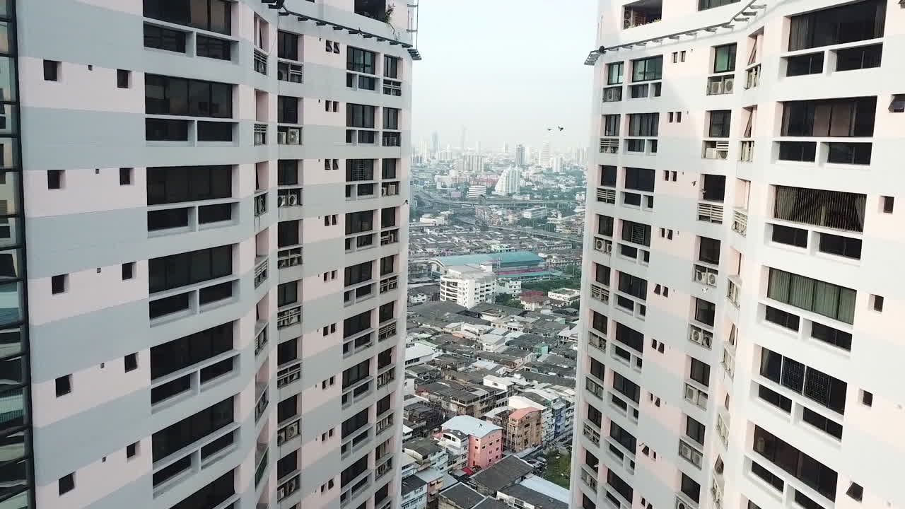 Drone Aerial View of Upscale Apartment Buildings and Air Pollution Over Bangkok Downtown in Skyline, Thailand