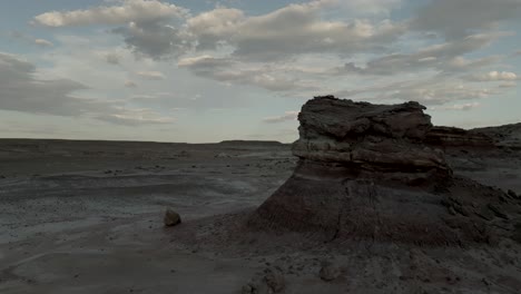 a butte formed by erosion in the desert - aerial at twilight